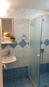a bathroom with a sink and a shower at Lemon Art Hotel Apartments in Tolo +25 photos