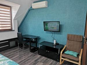 a room with a bed and a table and a tv at Pleven View in Pleven