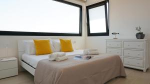 a bedroom with a large bed with towels on it at Postcard in Alghero