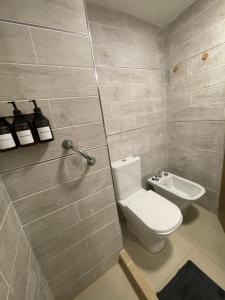 a bathroom with a toilet and a sink at Los Lapachos in Paraná +14 photos