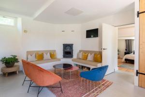 a living room with a couch and chairs and a table at Gîte de Fompesquiere in Frespech