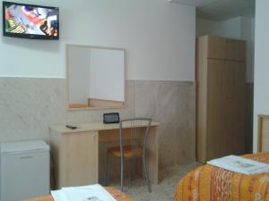 a small room with a desk and a mirror at Hotel Diffuso Montedoro in Montedoro