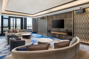 a living room with couches and a fireplace at Sheraton Zibo Hotel in Zibo
