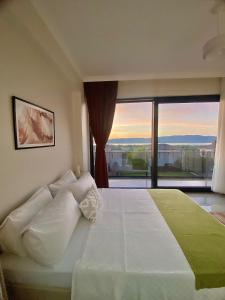 a bedroom with a large bed with a large window at High Garden Villas in Sapanca +27 photos