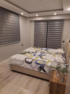 a bedroom with a bed and a table and windows at Villa Nimo 5 plus 1 for Rent with Private Pool in Antalya +19 photos