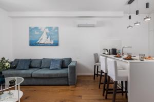 a living room with a couch and a sail boat on the wall at Luxury apartment Mon Soleil 2 in Murter