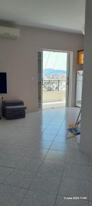 an empty living room with a view of a room with a floor at Liv Skyline Apartment in Sarandë
