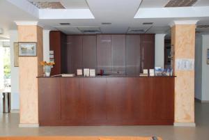 a lobby with a wooden reception desk in a building at Kastri Hotel in Néa Meságkala