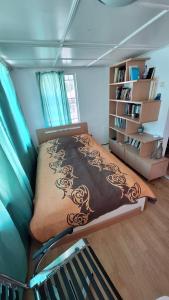 a bedroom with a bed and a book shelf at Apartments Londa in Jūrmala