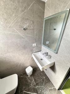 a bathroom with a sink and a mirror at Villa Soni Oruci in Ksamil +79 photos