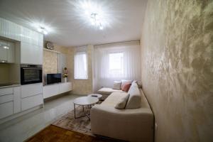 a living room with a couch and a table at Lux Apartman Novi Grad in Bosanski Novi