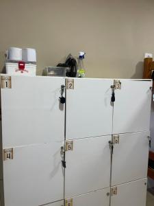 a stack of white cabinets in a kitchen at Estação Noronha in Fernando de Noronha