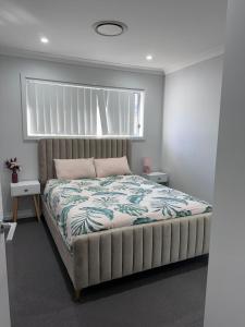 a bedroom with a large bed with a large window at Modern Luxury with Nature in Camden