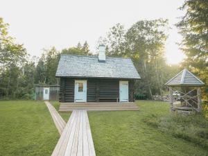 a log cabin with a deck and a gazebo at Panga Sauna Hut in Lähtru