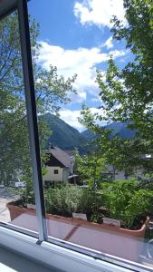 a window with a view of trees and mountains at Apartment Dajana in Bovec