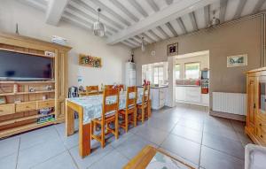 a kitchen with a table and chairs and a television at Awesome Home In Arques La Bataille in Arques-la-Bataille