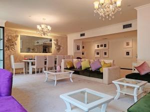 a living room with a couch and a table at ELAN RIMAL SADAF Suites in Dubai