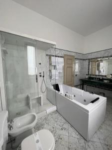 a bathroom with a tub and a shower and a toilet at Hotel Villa La Bollina in Serravalle Scrivia