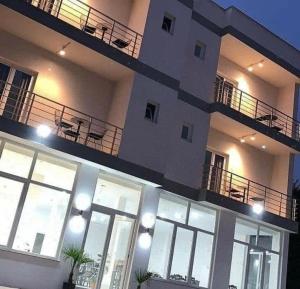a large building with windows and a balcony at Kompleksi Tre Shqiponjat in Velipojë