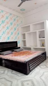 a bedroom with a large bed in a room at Awadh Royals Homestay Ayodhya in Ayodhya