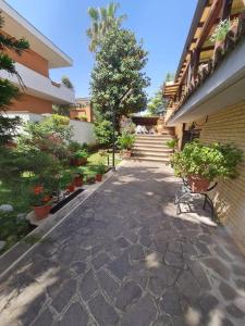a walkway with potted plants and stairs in a building at Villa Mattei Dreams in Rome