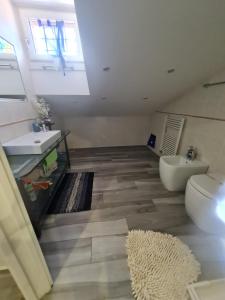 a bathroom with a sink and a toilet at Villa Mattei Dreams in Rome