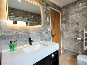 a bathroom with a white sink and a mirror at Meadow View Apartments are 2 and 3 bedroomed with private parking in Newquay +63 photos