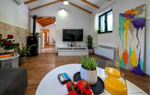 a living room with a table and a tv at Villa Silentio Dalmatia in Makarska