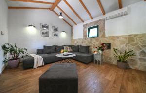a living room with a couch and a stone wall at Villa Silentio Dalmatia in Makarska