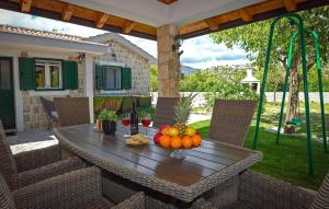 a table with fruit on it on a patio at Villa Silentio Dalmatia in Makarska +23 photos