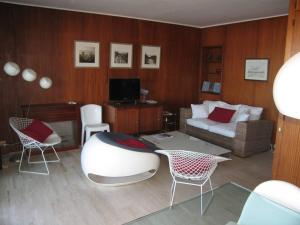 a living room with a couch and a table and chairs at Appartement Saint-Cyprien, 3 pièces, 6 personnes - FR-1-106-62 in Saint-Cyprien