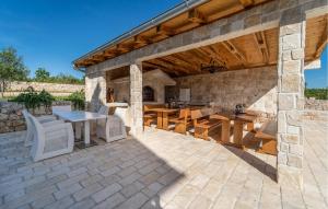an outdoor patio with a table and chairs at Beautiful Home In Slivnica With Wifi in Slivnica +37 photos