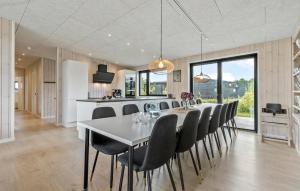a kitchen and dining room with a white table and chairs at Lovely Home In Glesborg With Wifi in Glesborg