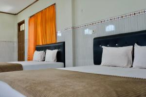 Letto o letti in una camera di Garuda Setia Hotel