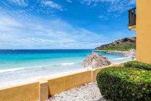 a view of the beach from a building at NEW! Right at the Beach! Curazure Beach Condo, Jan Thiel in Willemstad