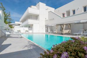 a villa with a swimming pool and a house at Diva Luxury Suite in Torre San Giovanni Ugento