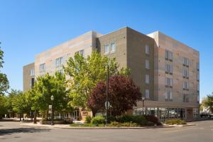 a building on a street with trees in front at SpringHill Suites by Marriott Grand Junction Downtown/Historic Main Street in Grand Junction