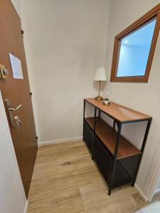 a desk with a lamp and a window in a room at Le 19 #Terrasse#Parking in Clermont-Ferrand +10 photos