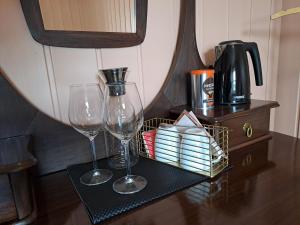 two wine glasses and a basket on a table at Bay View Island Room - Svanøy in Svanøy