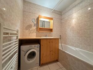 a bathroom with a washing machine and a sink at Appartement T2 au centre de Samoëns avec parking, animaux acceptés - FR-1-624-43 in Samoëns +11 photos