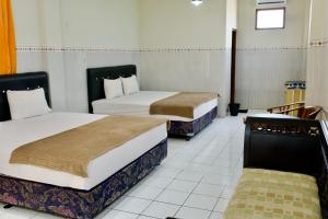 Letto o letti in una camera di Garuda Setia Hotel