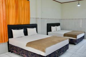 Katil atau katil-katil dalam bilik di Garuda Setia Hotel