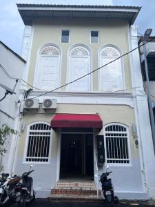 two motorcycles parked in front of a building at Sunshine House in George Town