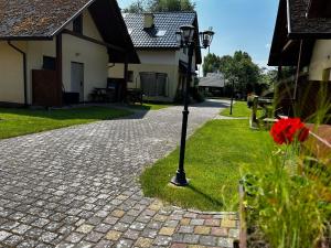 a street light in the grass next to a house at Kameleon Dźwirzyno in Dźwirzyno +36 photos
