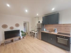 a kitchen with black cabinets and a counter top at Le Coquillage in Istres