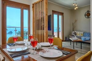a dining room with a table with wine glasses at Alegeo Apartment in Parga +33 photos