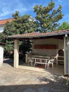 a pavilion with a table and chairs on a patio at Green Oasis Villa in Gevgelija