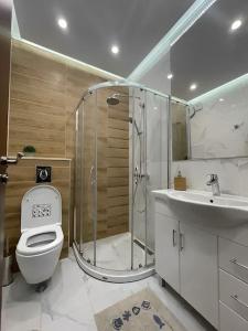 ein Badezimmer mit Dusche, Toilette und Waschbecken in der Unterkunft HOT Main Square Newly Built Modern Apartment in Burgas City + 11 Fotos