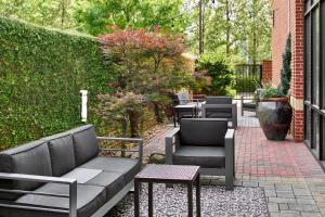 a patio with couches and chairs and a table at Courtyard by Marriott Atlanta NE/Duluth Sugarloaf in Duluth