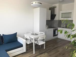 ein Wohnzimmer mit Tisch und Stühlen in einer Küche in der Unterkunft HOT Main Square Newly Built Modern Apartment in Burgas City